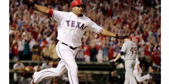 Texas Rangers' Nelson Cruz reacts after hitting a grand slam home run off of Detroit Tigers Ryan Perry, rear to win Game 2 of baseball's American League championship series 7-3, Monday, Oct. 10, 2011, in Arlington, Texas. (AP Photo/Charlie Riedel)