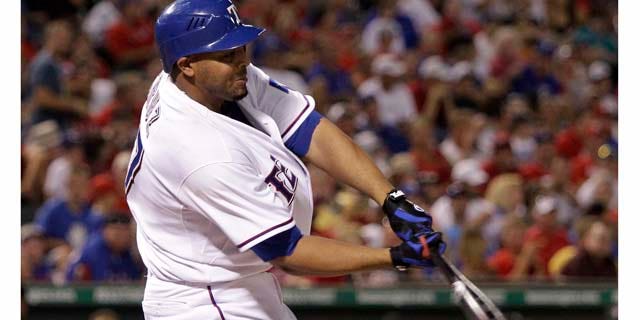 Texas Rangers' Nelson Cruz connects for an two-run single off Toronto Blue Jays reliever Shawn Camp in the sixth inning of a baseball game on Friday, July 22, 2011, in Arlington, Texas. Cruz had eight RBIs in the 12-2 Rangers win. (AP Photo/Tony Gutierrez)