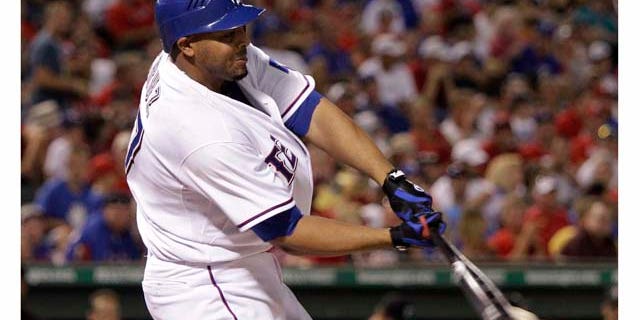 Texas Rangers' Nelson Cruz connects for an two-run single off Toronto Blue Jays reliever Shawn Camp in the sixth inning of a baseball game on Friday, July 22, 2011, in Arlington, Texas. Cruz had eight RBIs in the 12-2 Rangers win. (AP Photo/Tony Gutierrez)