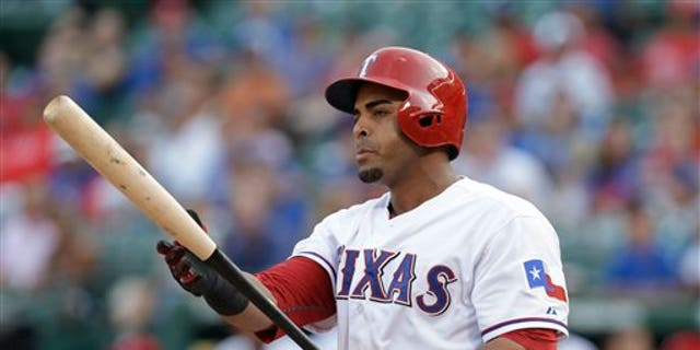 In this Aug. 1, 2013, photo, Texas Rangers' Nelson Cruz prepares for his at-bat during the second inning of a baseball game against the Arizona Diamondbacks in Arlington, Texas. A person familiar with the deal tells The Associated Press that Cruz, a free agent, and the Baltimore Orioles have reached agreement on a one-year contract. The person spoke Saturday, Feb. 22, 2014, on condition of anonymity because the contract was not complete. Cruz will earn about $8.5 million, and can make more in performance bonuses. Other media outlets had reported a deal was in place. (AP Photo/LM Otero)
