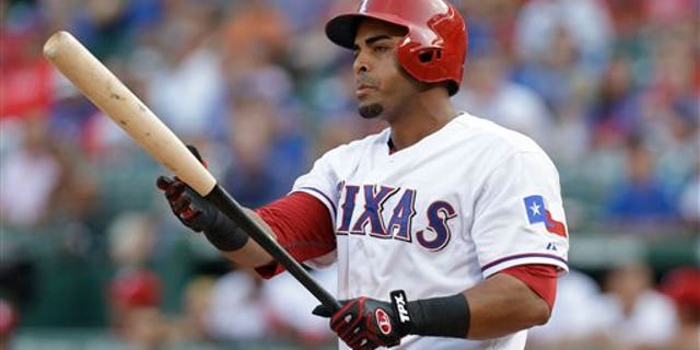 In this Aug. 1, 2013, photo, Texas Rangers' Nelson Cruz prepares for his at-bat during the second inning of a baseball game against the Arizona Diamondbacks in Arlington, Texas. A person familiar with the deal tells The Associated Press that Cruz, a free agent, and the Baltimore Orioles have reached agreement on a one-year contract. The person spoke Saturday, Feb. 22, 2014, on condition of anonymity because the contract was not complete. Cruz will earn about $8.5 million, and can make more in performance bonuses. Other media outlets had reported a deal was in place. (AP Photo/LM Otero)