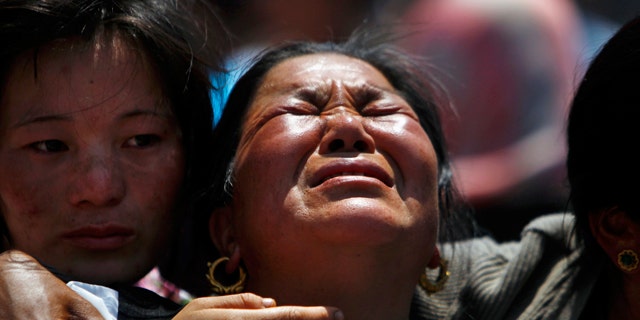 April 21, 2014: Relatives of mountaineers killed in an avalanche on Mount Everest cry during the funeral ceremony in Katmandu, Nepal.