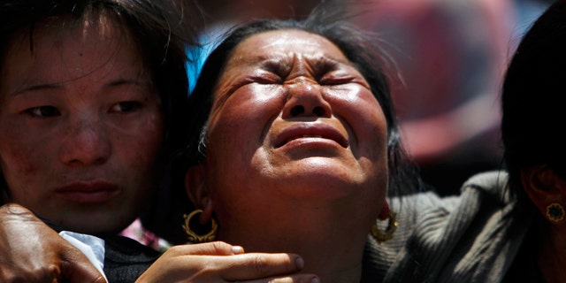 April 21, 2014: Relatives of mountaineers killed in an avalanche on Mount Everest cry during the funeral ceremony in Katmandu, Nepal.