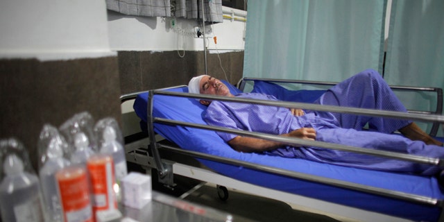 Spanish trekker Juan Mari Eguillor, 68, who survived a landslide receives treatment at Vayodha Hospital in Kathmandu, Nepal, Thursday, Sept. 22, 2016. A Spanish trekker and three Nepalese guides were killed Thursday and more than a dozen injured when they were hit by a landslide triggered by heavy rain in Nepal's northern mountains, officials said.(AP Photo/Niranjan Shrestha)