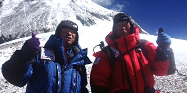 May 22, 2013: 80-year-old Japanese extreme skier Yuichiro Miura, right, and his son, Gota pose at their South Col camp at 26,247 feet before their departure for Camp 5 during their attempt to scale the summit of Mount Everest.