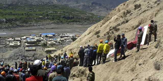 May 14: Nepalese rescue workers and officials inspect the site of a plane crash near Jomsom, 125 miles northwest of the capital, Katmandu.