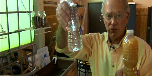 Water Missions International co-founder and CEO George Greene holds samples of water taken after and before the purification process.