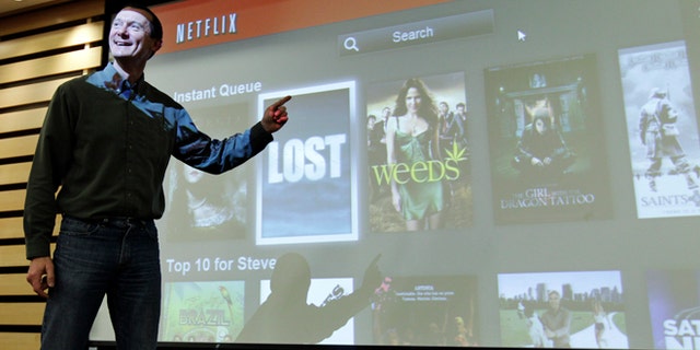 March 20, 2012: Netflix Chief Product Officer Neil Hunt points out popular movies on Netflix at a theater inside Netflix headquarters in Los Gatos, Calif.