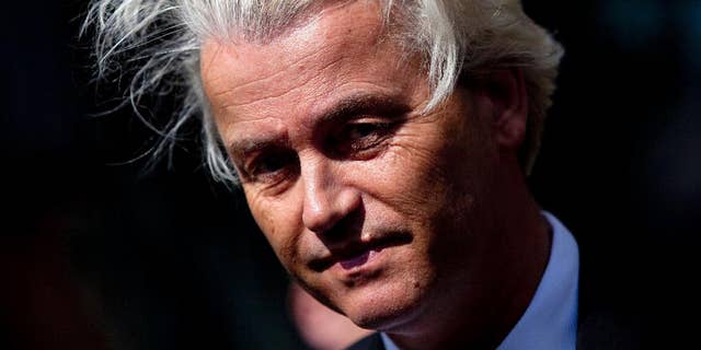 FILE - In this May 12, 2014 file photo Dutch lawmaker Geert Wilders pauses, as he speaks to journalists outside the Dutch National Bank in Amsterdam. Dutch authorities on Thursday, Dec. 18, 2014, said they will prosecute Wilders for hate speech over a chant in which he asked his supporters whether they wanted more or fewer Moroccans in the Netherlands and they shouted back “Fewer! Fewer! Fewer!” The announcement marks the second time Wilders has faced charges linked to his anti-immigrant and anti-Islam rhetoric. He was acquitted of similar charges in 2011 for comparing Islam with Naziism and calling for a ban on the Quran. (AP Photo/Peter Dejong, File)