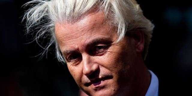 FILE - In this May 12, 2014 file photo Dutch lawmaker Geert Wilders pauses, as he speaks to journalists outside the Dutch National Bank in Amsterdam. Dutch authorities on Thursday, Dec. 18, 2014, said they will prosecute Wilders for hate speech over a chant in which he asked his supporters whether they wanted more or fewer Moroccans in the Netherlands and they shouted back “Fewer! Fewer! Fewer!” The announcement marks the second time Wilders has faced charges linked to his anti-immigrant and anti-Islam rhetoric. He was acquitted of similar charges in 2011 for comparing Islam with Naziism and calling for a ban on the Quran. (AP Photo/Peter Dejong, File)