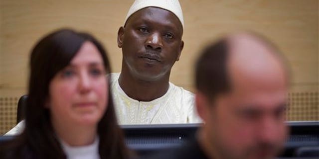 March 14, 2012: Congolese warlord Thomas Lubanga, center, awaits his verdict in the courtroom of the International Criminal Court (ICC) in The Hague, Netherlands.
