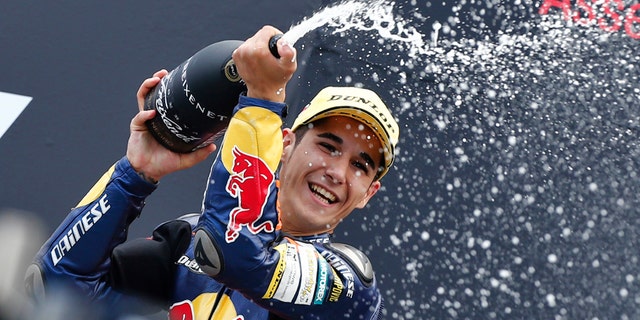 FILE, In this Saturday June 29 2013 file photo, Luis Salom of Spain celebrates his victory during the podium ceremony of the Moto3 race of the Dutch Grand Prix in Assen, northern Netherlands. MotoGP officials say Moto2 rider Luis Salom has died after crashing during practice for the Catalunya Grand Prix on Friday. He was 24. The death was announced at a news conference at the Barcelona circuit. (AP Photo/Vincent Jannink, File)
