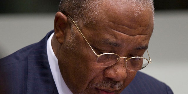 April 26, 2012: Former Liberian President Charles Taylor takes notes as he waits for the start of a hearing to deliver verdict in the court room of the Special Court for Sierra Leone in Leidschendam, near The Hague, Netherlands.