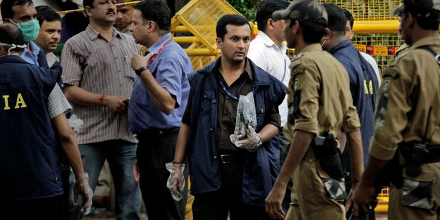 September 8: An officer of the National Investigation Agency (NIA) stands with the evidence collected from the site of a blast at Delhi High court in New Delhi, India.