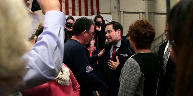 In this Jan. 21, 2016, photo Republican presidential candidate, Sen. Marco Rubio, R-Fla., talks with Bob Belanger, from Brookline, N.H., after a campaign stop at a welding company in Brookline. Illegal immigration is a paramount concern to New Hampshire voters, and Republican presidential candidates are being faced with tough questions from voters in this small, mostly white, state on how they will handle the issue if elected. Belanger said immigration concerns among New Hampshire residents do not equate to xenophobia. (AP Photo/Charles Krupa)