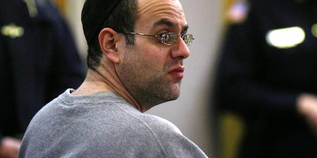 FILE- In this Friday, Oct. 19, 2012 file photograph, Solomon Dwek waits to be sentenced in state Superior Court in Freehold, N.J. Dwek was released from a federal prison in Maryland this week. He was placed into home confinement after serving less than 30 months of a 6-year sentence. The 42-year-old son of a prominent rabbi began cooperating with the FBI as part of a plea agreement after he was accused of running a real estate Ponzi scheme. (AP Photo/The Star-Ledger, Patti Sapone, Pool, file)
