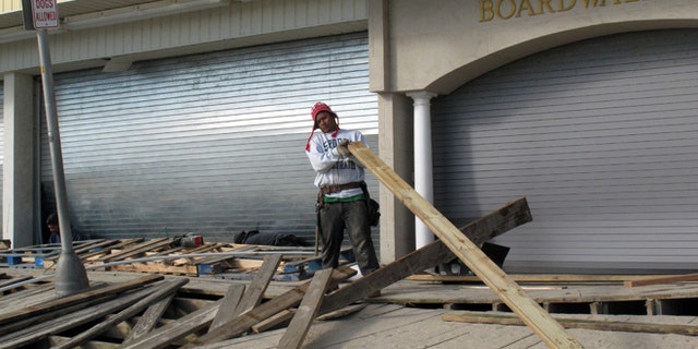 FILE: Nov. 1, 2012:  A worker repairs the Point Pleasant Beach, N.J., boardwalk after Superstorm Sandy wrecked parts of it.