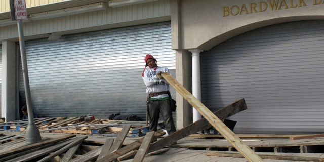 FILE: Nov. 1, 2012: A worker repairs the Point Pleasant Beach, N.J., boardwalk after Superstorm Sandy wrecked parts of it.