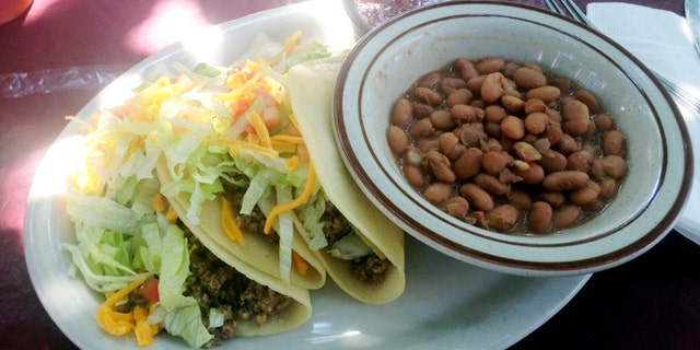 In this Sept 5, 2013 photo, a soft taco plate from El Patio de Albuquerque is shown. El Patio is a longtime, unpretentious eatery near Albuquerqueâs University of New Mexico campus, and is one of the cityâs most popular dining spots. For nearly four decades, multi-generational families, tourists, professors, students _ even celebrities _ have lined up outside this former house for robust but simple fare. (AP Photo/Russell Contreras)