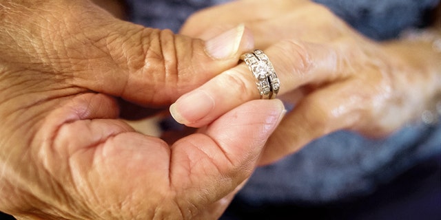 Robert Kirker puts a wedding ring, lost for 30 years, on his wife Ofelia's hand at their home in Las Cruces, N.M., May 27, 2015. (Jett Lowe/Las Cruces Sun-News via AP)