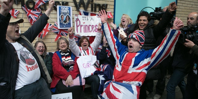 Royal fans and well wishers react after Kensington Palace announced that Kate, the Duchess of Cambridge, had given birth to a girl, outside the Lindo Wing of St. Mary's Hospital, London, Saturday, May 2, 2015. Kensington Palace said in a brief statement that Prince William's wife "was safely delivered of a daughter" at 8:34 a.m. London time (0734 GMT), less than three hours after she was admitted to central London's St. Mary's Hospital. (Daniel Leal-Olivas/PA via AP) UNITED KINGDOM OUT, NO SALES, NO ARCHIVE