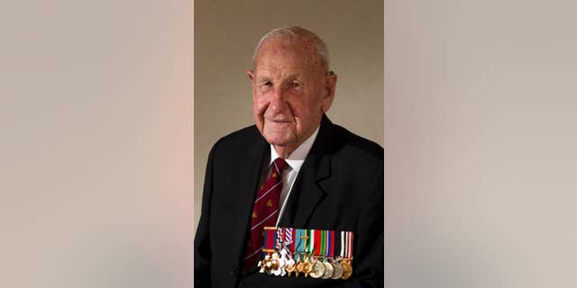 In this March 3, 2015, photo, veteran Les Munro poses for a photo at his home in Tauranga, New Zealand. Munro, 96, the last surviving pilot from the specialized World War II “Dambuster” mission targeting German infrastructure died Tuesday, Aug. 4, 2015. (Alan Gibson/New Zealand Herald via AP) NEW ZEALAND OUT, AUSTRALIA OUT