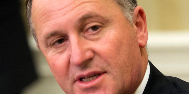 FILE - In this June 20, 2014 file photo, New Zealand's Prime Minister John Key listens to U.S. President Barack Obama in the Oval Office. Key apologized to a cafe worker who said he'd repeatedly pulled her ponytail when he visited the cafe near his home over a period of months, even after she'd told him to stop. (AP Photo/Pablo Martinez Monsivais, File)