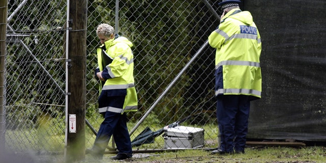 Sept. 20, 2015: Police stand at the shut gates at the Hamilton (New Zealand) Zoo after a female zookeeper was killed by one of its tigers. Police said the woman died at the scene, and asked the zoo to order all visitors to leave and close its doors until Thursday. (Nick Reed/New Zealand Herald via AP).