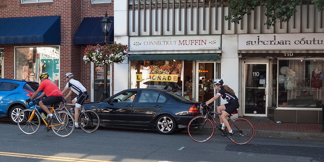 Downtown New Canaan, Conn., is filled with local boutiques and restaurants. Residents argue 'for sale' signs take away from the town's charm.