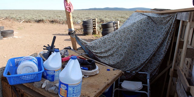 An improvised bathroom stands inside a squalid makeshift living compound in Amalia, New Mexico, on Friday.