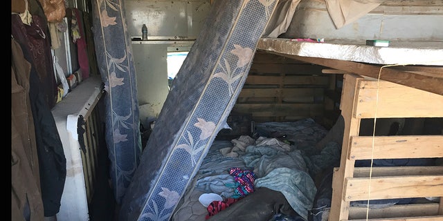 The back of a moving truck serves as sleeping quarters at a squalid makeshift living compound in Amalia, New Mexico, on Friday.