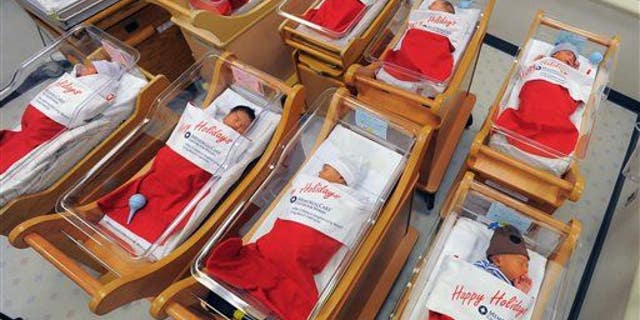 Newborns sleep in oversized red stockings in the nursery at Long Beach Memorial in Long Beach, Calif., on Monday, Dec. 23, 2013.