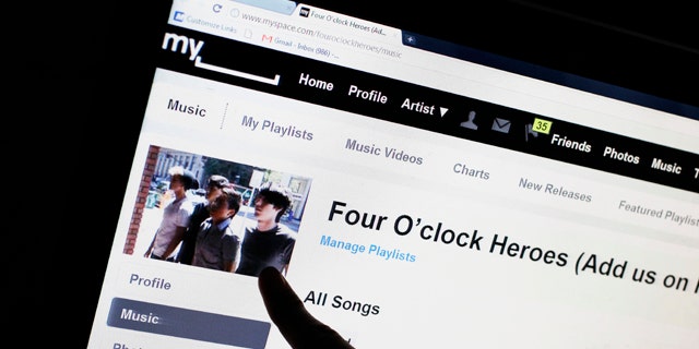June 29, 2011: Bass guitarist Cameron Schnittger, with the pop rock band Four O'clock Heroes, points to his picture on on the bands' MySpace web site page in San Jose, Calif. News Corp. has sold the struggling social networking site for $35 million, mostly in stock, according to a person familiar with the matter.