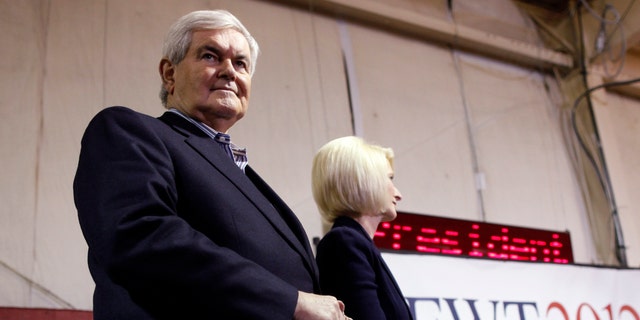 Republican presidential candidate former Speaker Newt Gingrich, stands with his wife Callista as he is introduced at his campaign headquarters in Davenport, Iowa, Monday, Jan. 2, 2012. (AP Photo/Charles Dharapak)