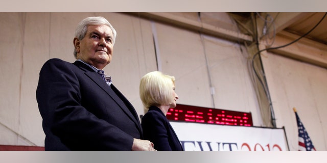 Republican presidential candidate former Speaker Newt Gingrich, stands with his wife Callista as he is introduced at his campaign headquarters in Davenport, Iowa, Monday, Jan. 2, 2012. (AP Photo/Charles Dharapak)