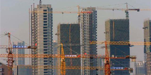 A housing development under construction in Shenyang, China, in 2009. "Ghost cities" have sprung up around the country as developers struggle to fill units.