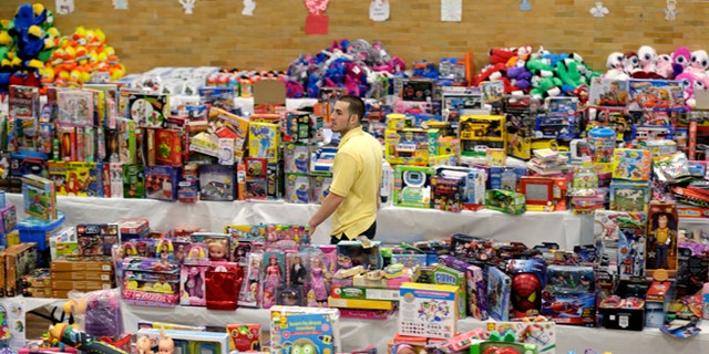 Dec. 21, 2012: Volunteer Anthony Vessicchio of East Haven, Conn., helps to sort tables full of donated toys at the town hall in Newtown, Conn.