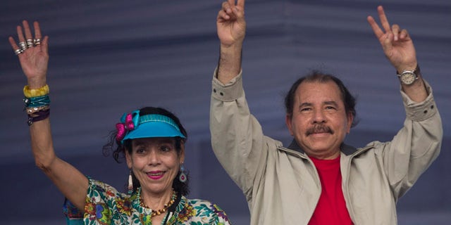 FILE.- In this July 3, 2016 file photo Nicaragua's President Daniel Ortega, right, and first lady Rosario Murillo, wave to supporters during an event commemorating the 36th anniversary of the Sandinista National Liberation Front withdrawal to Masaya, in Managua, Nicaragua. Murillo now running as her husband's VP ticket mate in a Nov. 6 election seen as a shoo-in and is poised to finally have the title to match her true influence. (AP Photo/Esteban Felix, File)