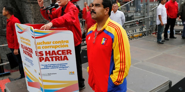 Venezuela's President Nicolas Maduro waits his turn to speak during a march against corruption, in Caracas, Venezuela, Aug. 3, 2013.