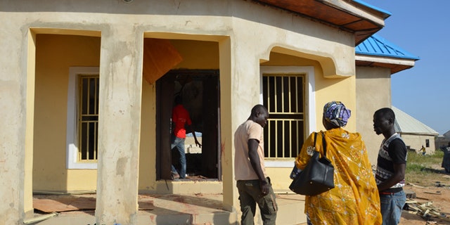 Oct. 23, 2015: People stand outside a mosque that was bombed in Maiduguri, Nigeria.