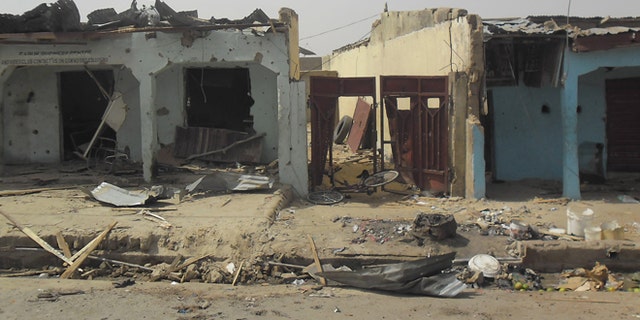 June 18, 2014: Bloodstains seen on the street and damage buildings following a suicide bomb explosion at a World cup viewing center in Damaturu, Nigeria. There was no immediate claim for the blast but Boko Haram was suspected.