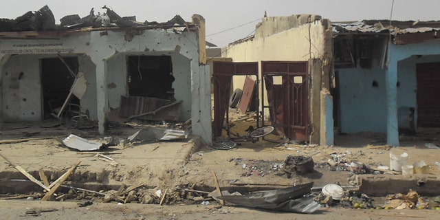 June 18, 2014: Bloodstains seen on the street and damage buildings following a suicide bomb explosion at a World cup viewing center in Damaturu, Nigeria. There was no immediate claim for the blast but Boko Haram was suspected.