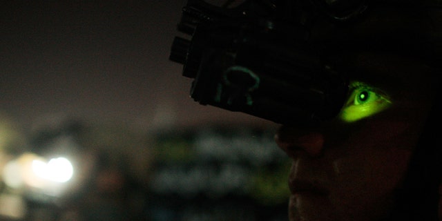 BAGHDAD, IRAQ - JUNE 25: (FRANCE OUT) A paratrooper from the 82nd Airborne Division's 1st Battalion, 325th Infantry Regiment looks through helmet-mounted night vision goggles during a night patrol on June 25, 2007 in the Hurriyah neighborhood of Baghdad, Iraq. The 82nd Airborne conducts night patrols almost every night in the Shia neighborhood in west Baghdad to enforce a 10 pm curfew. (Photo by Chris Hondros/Getty Images)