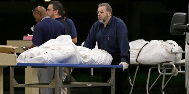 Two bodies of victims arrive at the Orlando Medical Examiner's Office, Sunday, June 12, 2016, in Orlando, Fla.