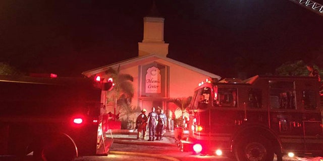In this photo provided by the St. Lucie Sheriff's Office, firefighters work at the scene of a fire at the Islamic Center of Fort Pierce on Monday, Sept. 12, 2016, in Fort Pierce, Fla. (St. Lucie Sheriff's Office via AP)