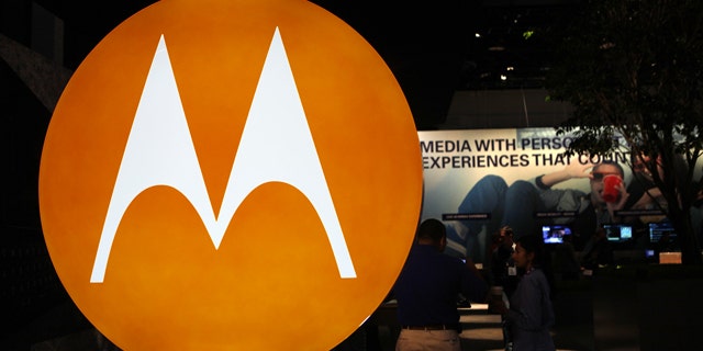 The Motorola logo is seen at the company's exhibit at the Consumer Electronics Show in Las Vegas. Motorola Inc. said Monday, July 19, 2010, that it is selling most of its wireless network division to Nokia Siemens Networks, a Finnish-German joint venture, for $1.2 billion as part of a planned breakup of the company.