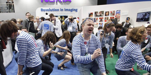 Feb. 27, 2012: Nokia staff dance after the presentation of the new Lumia 900 after a news conference during the Mobile World Congress in Barcelona.
