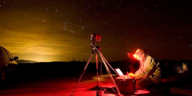 A photographer snaps the night sky with a special computer controlled camera in Death Valley National Park, Calif.