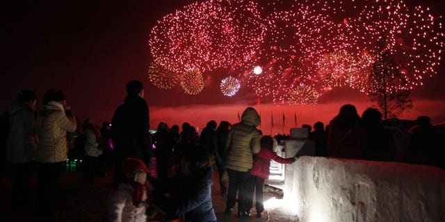 People in North Korea watch New Year's Day fireworks in Pyongyang.