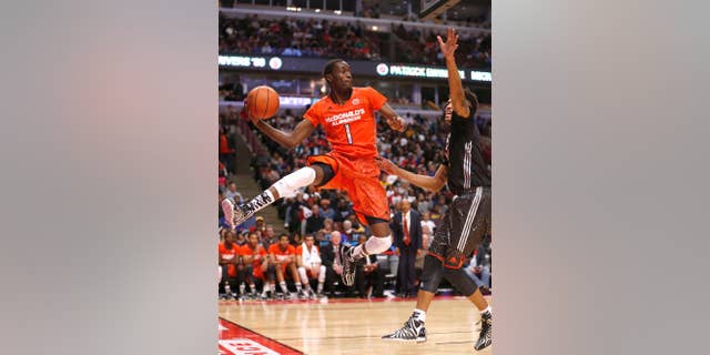 FILE - In this April 2, 2014, file photo, McDonald's East All-American Theo Pinson, left, saves the ball from going out-of-bounds as McDonald's West All-American Kelly Oubre defends during the second half of the McDonald's All-American boy's basketball game in Chicago. The 6-foot-6 Pinson arrived in Chapel Hill this summer and will help fill the Tar Heels' need for guard depth. (AP Photo/Charles Rex Arbogast, File)